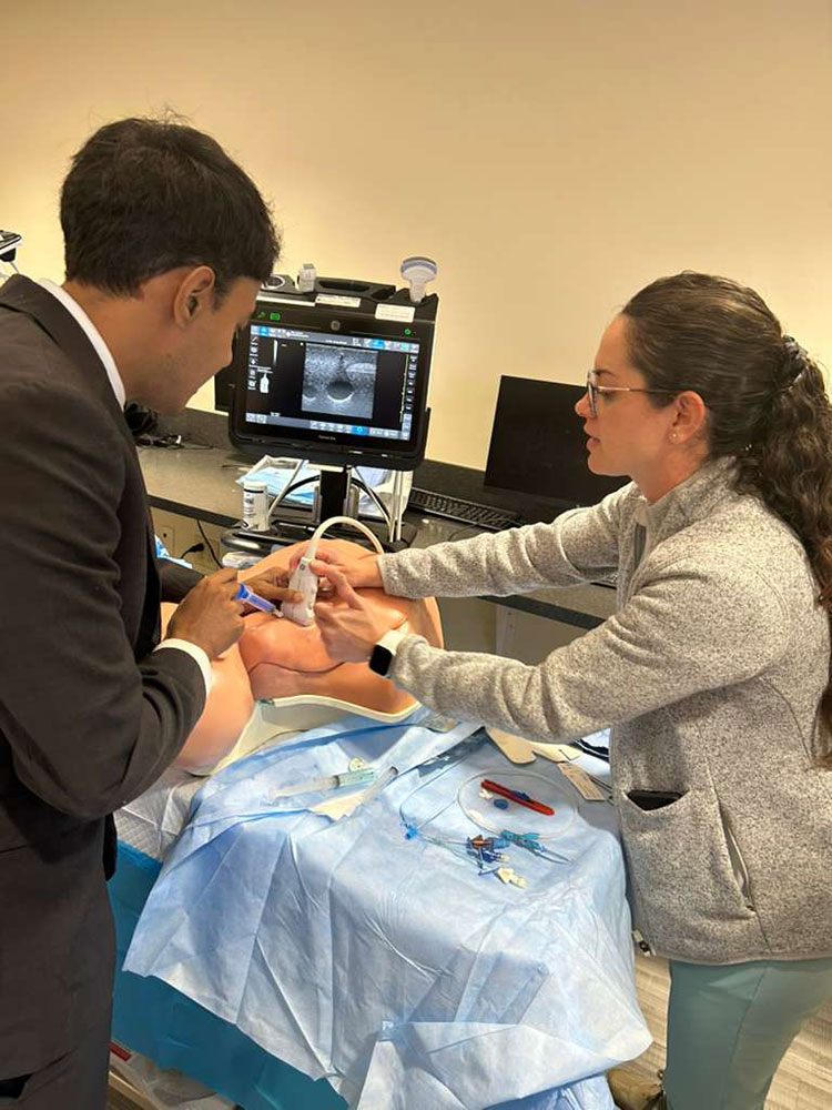 Residents working on a central line simulation