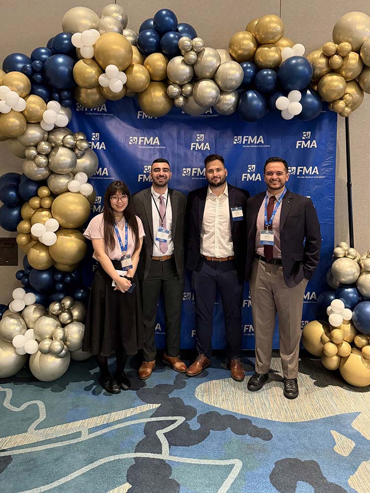 Group photo with blue, silver, and gold balloons - FMA 2026